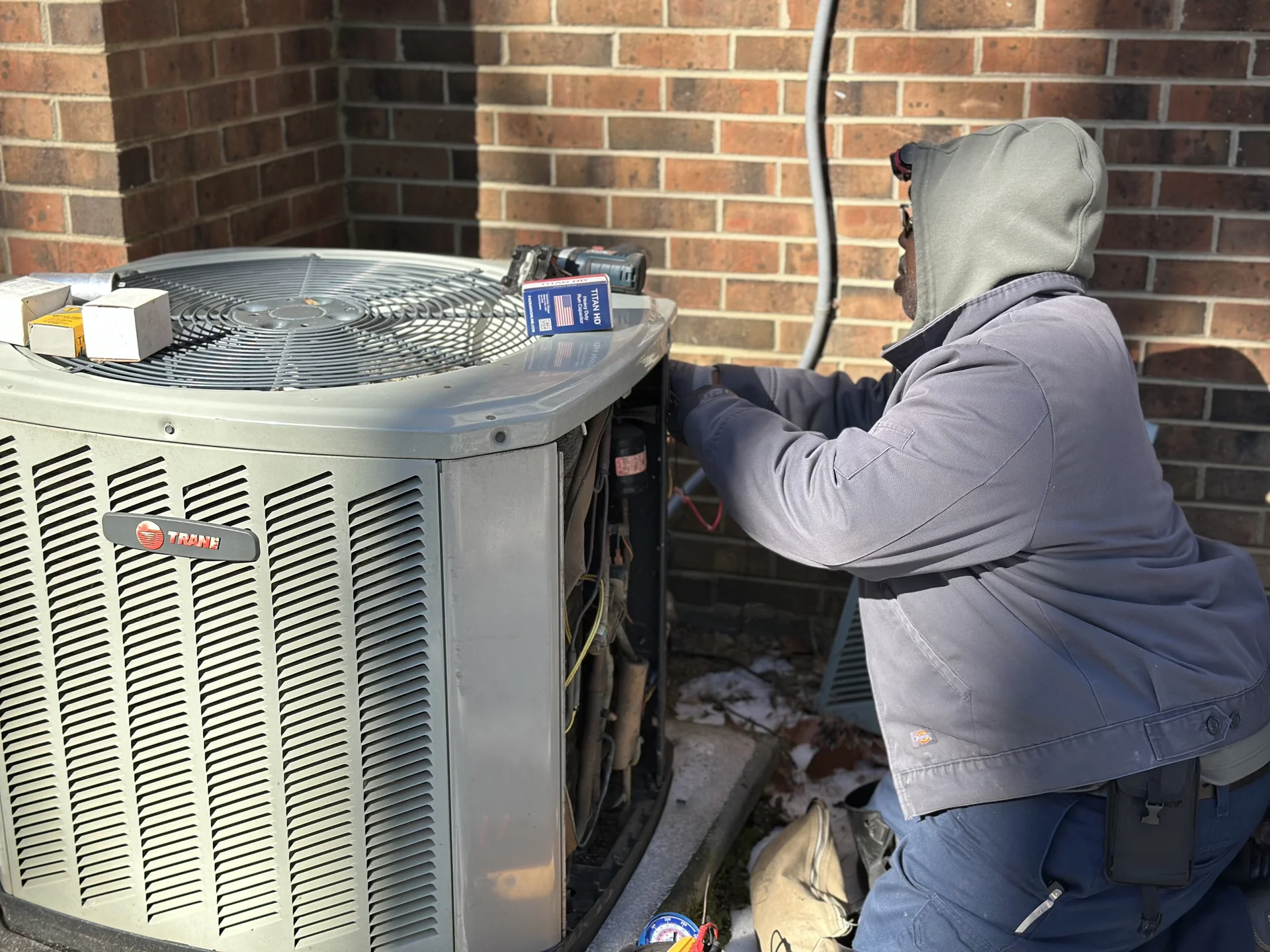 Icy Hot HVAC technician performing maintenance on a Trane outdoor unit in Raleigh, NC